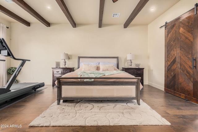 bedroom featuring beamed ceiling, a barn door, and dark hardwood / wood-style flooring