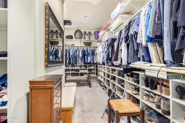 walk in closet featuring carpet