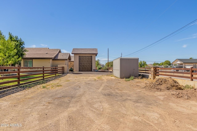 5039 S 158th St, Gilbert, AZ 85298 - view of front facade with fence, an outbuilding, and driveway