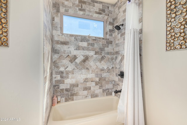 bathroom with shower / bathtub combination with curtain