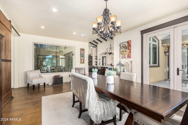 dining room featuring a barn door and dark hardwood / wood-style flooring