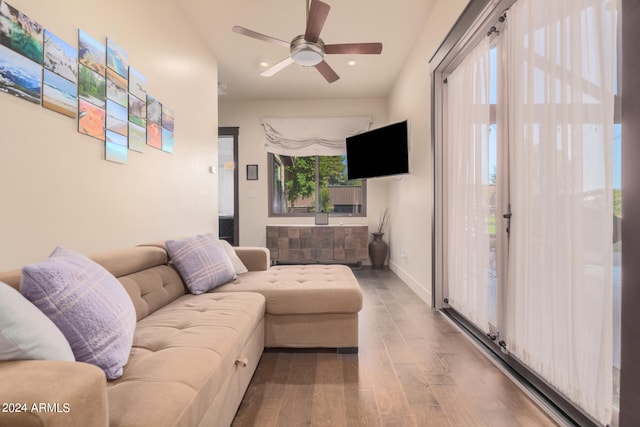 living room with wood-type flooring and ceiling fan