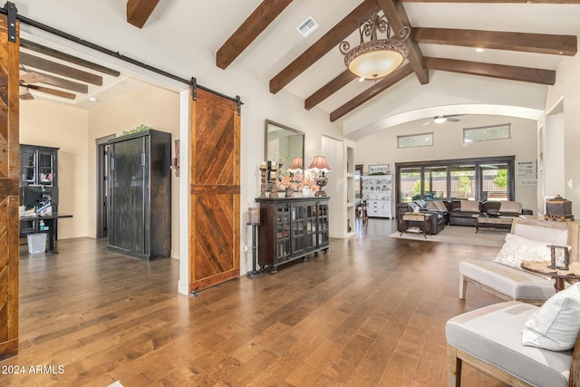 living room featuring ceiling fan, beam ceiling, high vaulted ceiling, hardwood / wood-style flooring, and a barn door