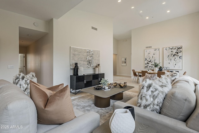 living area featuring visible vents, high vaulted ceiling, and recessed lighting