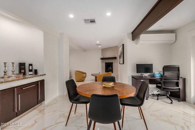 12821 N 67th St, Scottsdale, AZ 85254 - dining room featuring a wall mounted AC, light marble finish flooring, a fireplace, and recessed lighting