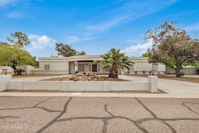 12821 N 67th St, Scottsdale, AZ 85254 - view of front of home with driveway, a fenced front yard, and stucco siding