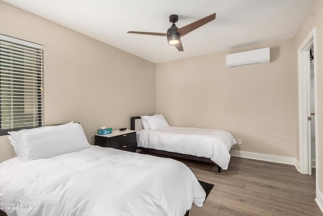 12821 N 67th St, Scottsdale, AZ 85254 - bedroom with a wall mounted air conditioner, wood finished floors, baseboards, and ceiling fan