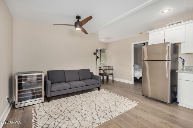 12821 N 67th St, Scottsdale, AZ 85254 - living room featuring wine cooler, ceiling fan, light wood-type flooring, baseboards, and recessed lighting