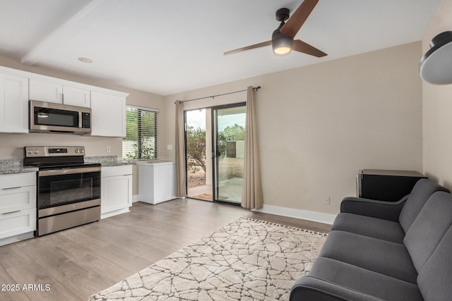 12821 N 67th St, Scottsdale, AZ 85254 - kitchen with stainless steel appliances, a ceiling fan, white cabinetry, and light wood-type flooring