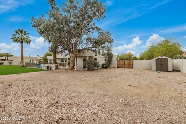 12821 N 67th St, Scottsdale, AZ 85254 - fenced backyard featuring a storage unit and an outdoor structure