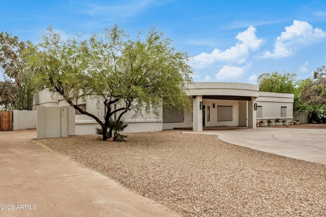 12821 N 67th St, Scottsdale, AZ 85254 - view of front facade with concrete driveway, fence, stucco siding, and an attached carport