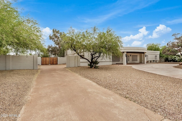 12821 N 67th St, Scottsdale, AZ 85254 - view of front of house featuring a gate, fence, stucco siding, and driveway