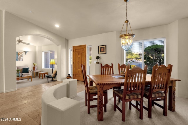 dining room featuring ceiling fan with notable chandelier