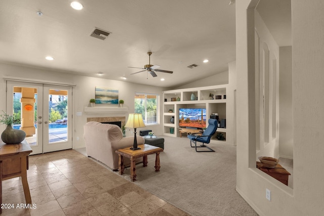 living room featuring french doors, built in features, lofted ceiling, light colored carpet, and ceiling fan