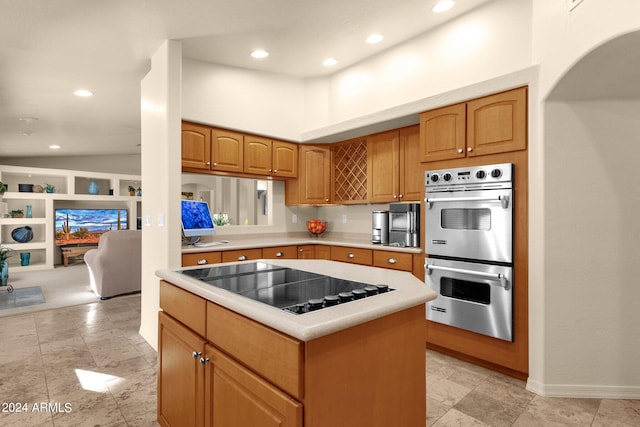 kitchen featuring stainless steel double oven, black electric cooktop, high vaulted ceiling, and a center island