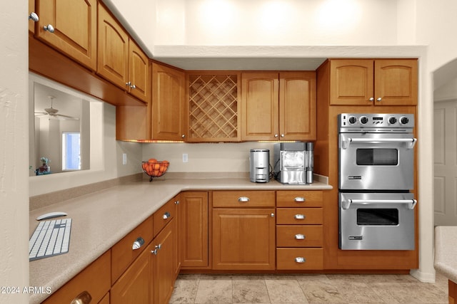 kitchen featuring stainless steel double oven and ceiling fan