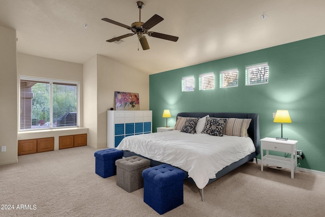 bedroom with lofted ceiling, ceiling fan, and light carpet