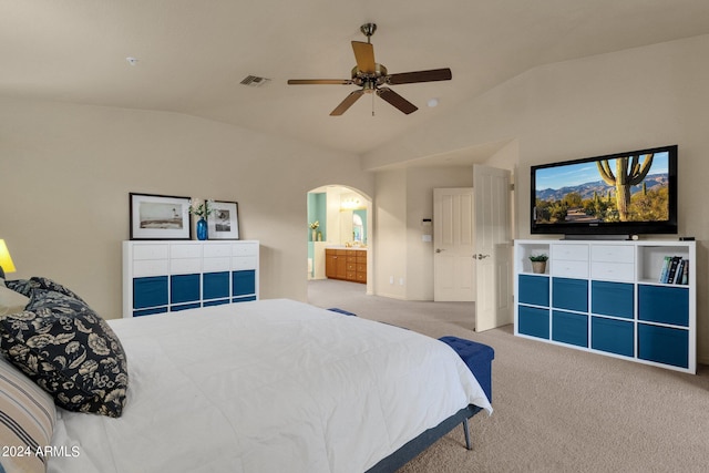 carpeted bedroom featuring lofted ceiling, ceiling fan, and ensuite bathroom