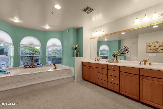 bathroom featuring a tub to relax in and vanity