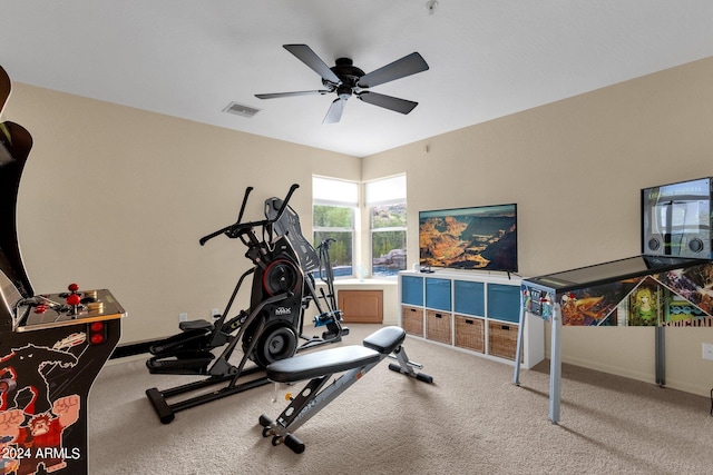 exercise area featuring ceiling fan and carpet flooring