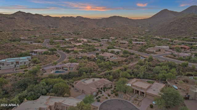 aerial view at dusk featuring a mountain view