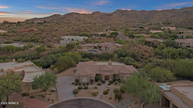 aerial view at dusk featuring a mountain view