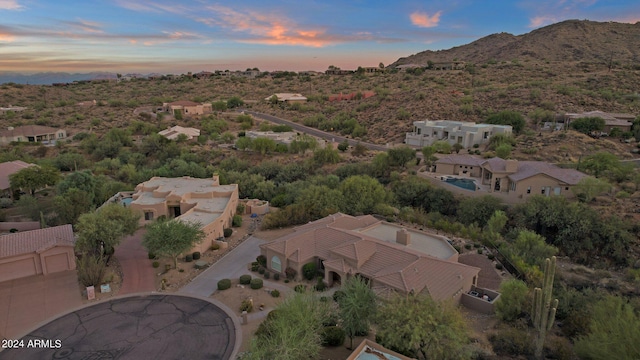 aerial view at dusk featuring a mountain view