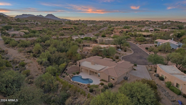 aerial view at dusk featuring a mountain view