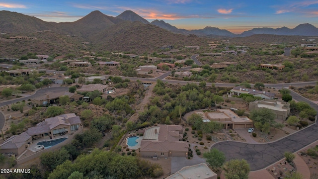 aerial view at dusk featuring a mountain view