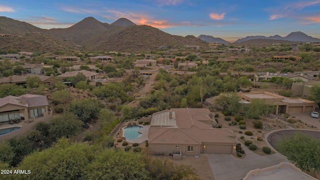 aerial view at dusk featuring a mountain view