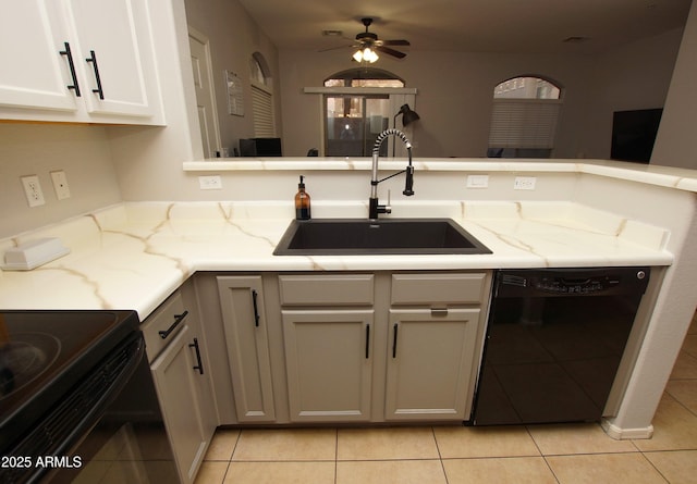 kitchen with light stone counters, sink, light tile patterned floors, and dishwasher