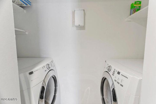 laundry area with washing machine and clothes dryer