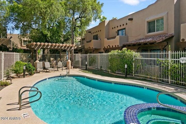 view of swimming pool featuring a patio and a community hot tub