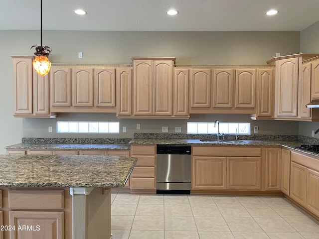 kitchen featuring dark stone countertops, sink, dishwasher, and light tile flooring