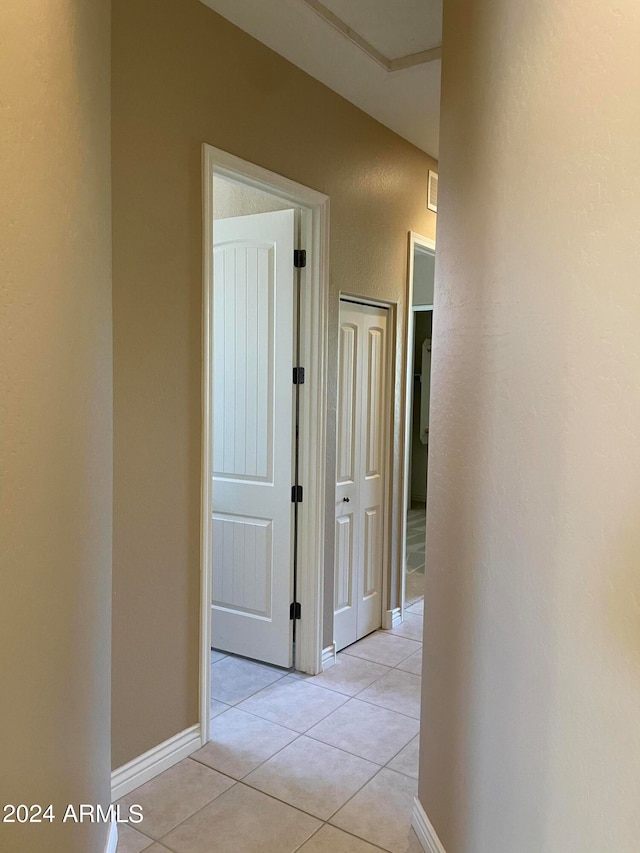 hall featuring light tile flooring