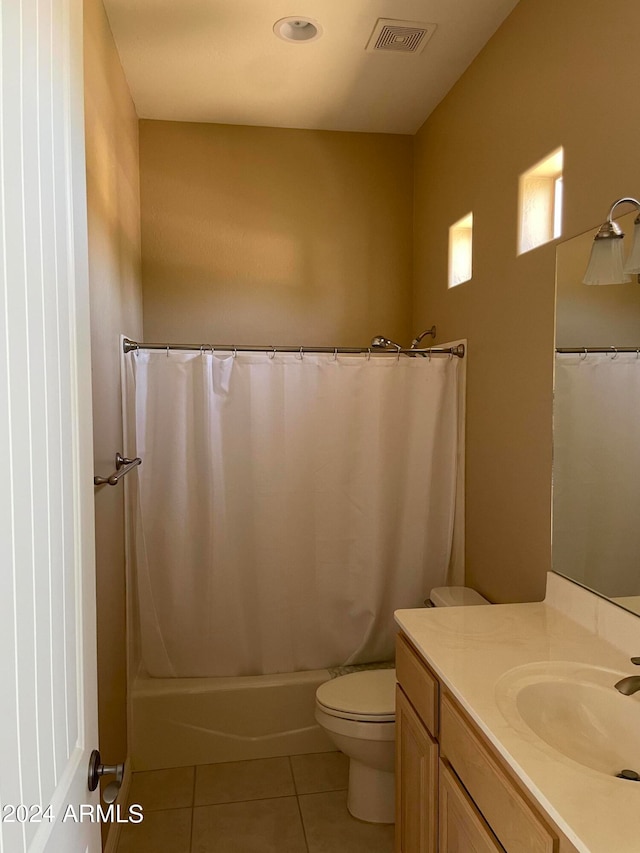 full bathroom with toilet, tile floors, vanity, and shower / bath combination with curtain