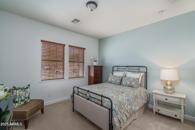 carpeted bedroom with baseboards and visible vents