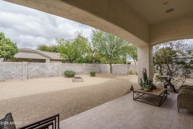 view of patio / terrace with an outdoor fire pit and a fenced backyard