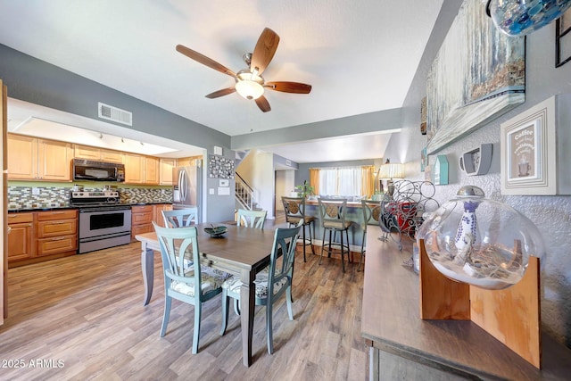 2524 S El Paradiso Dr Unit 82, Mesa, AZ 85202 - dining space with ceiling fan, stairs, and light wood-style flooring