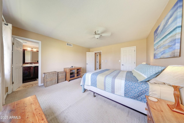 2524 S El Paradiso Dr Unit 82, Mesa, AZ 85202 - bedroom featuring light carpet, ceiling fan, and ensuite bathroom