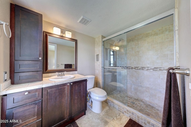 2524 S El Paradiso Dr Unit 82, Mesa, AZ 85202 - bathroom featuring toilet, a shower stall, vanity, a textured ceiling, and tile patterned flooring