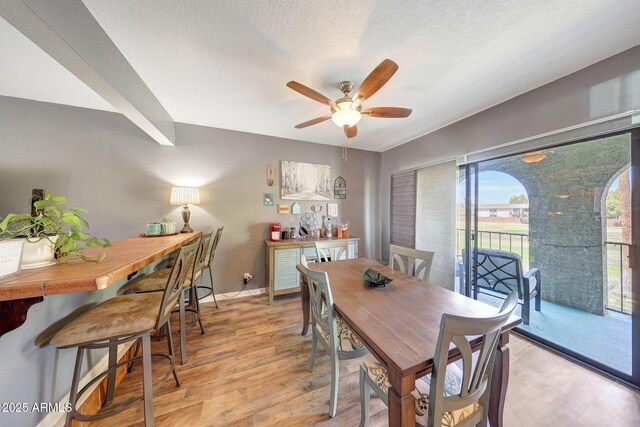 2524 S El Paradiso Dr Unit 82, Mesa, AZ 85202 - dining space with light wood finished floors, a ceiling fan, a textured ceiling, and baseboards