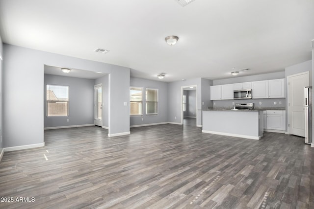 unfurnished living room featuring dark hardwood / wood-style floors