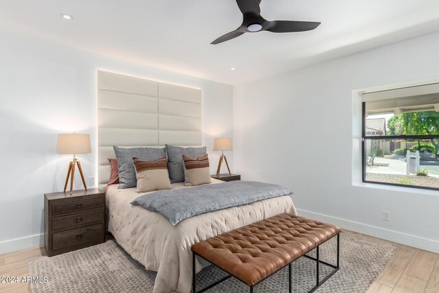 bedroom with ceiling fan and light hardwood / wood-style floors