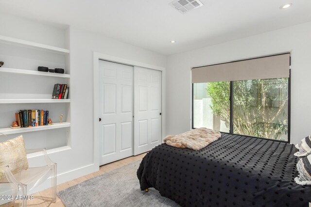 bedroom featuring light hardwood / wood-style flooring and a closet