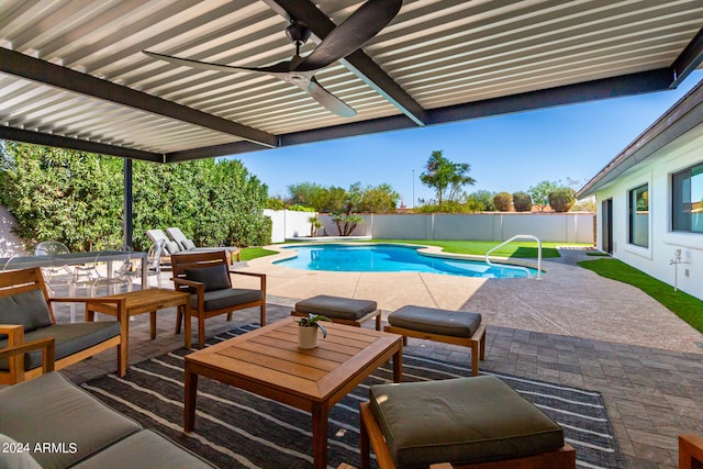 view of pool with ceiling fan and a patio