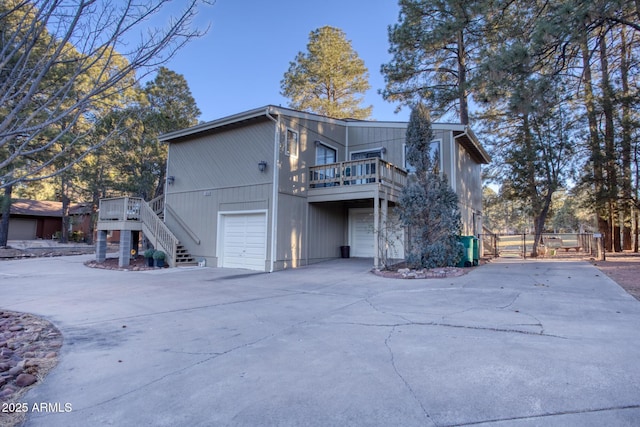 rear view of property featuring a garage and a deck