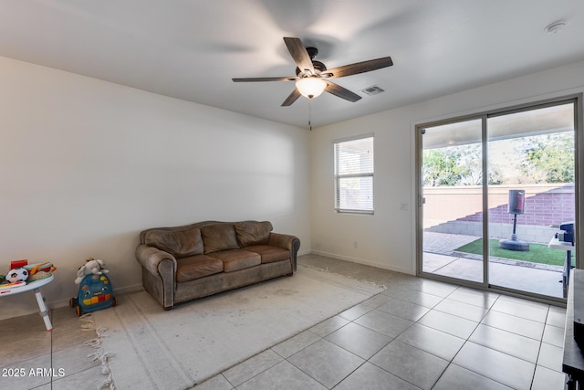 unfurnished living room with ceiling fan and light tile patterned floors