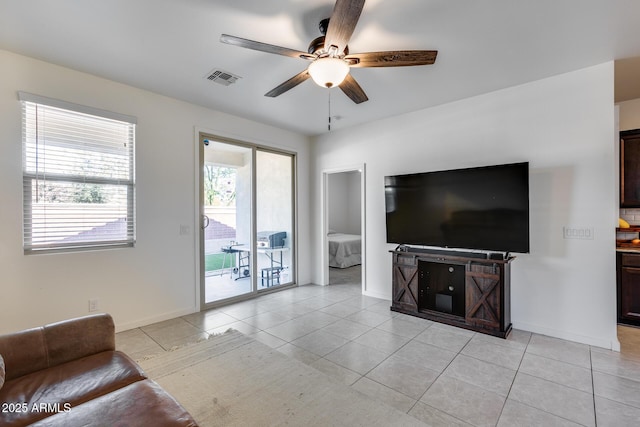 unfurnished living room with ceiling fan and light tile patterned flooring