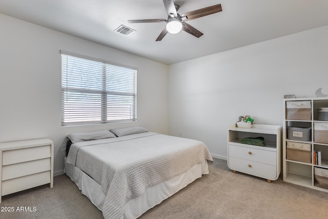 bedroom with ceiling fan, light carpet, and multiple windows